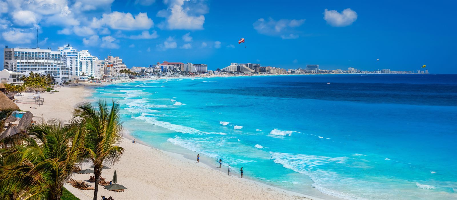 Turquoise Caribbean water and white beach below hotels in Cancun, a favorite cruise coupon getaway