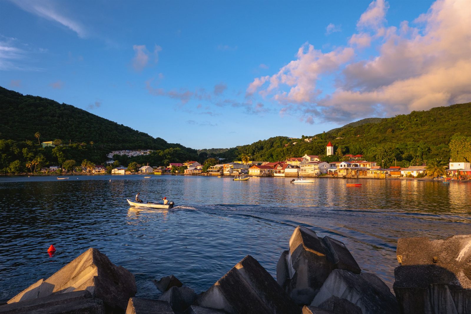 Harbor town on a Caribbean island at golden hour with boats in the bay